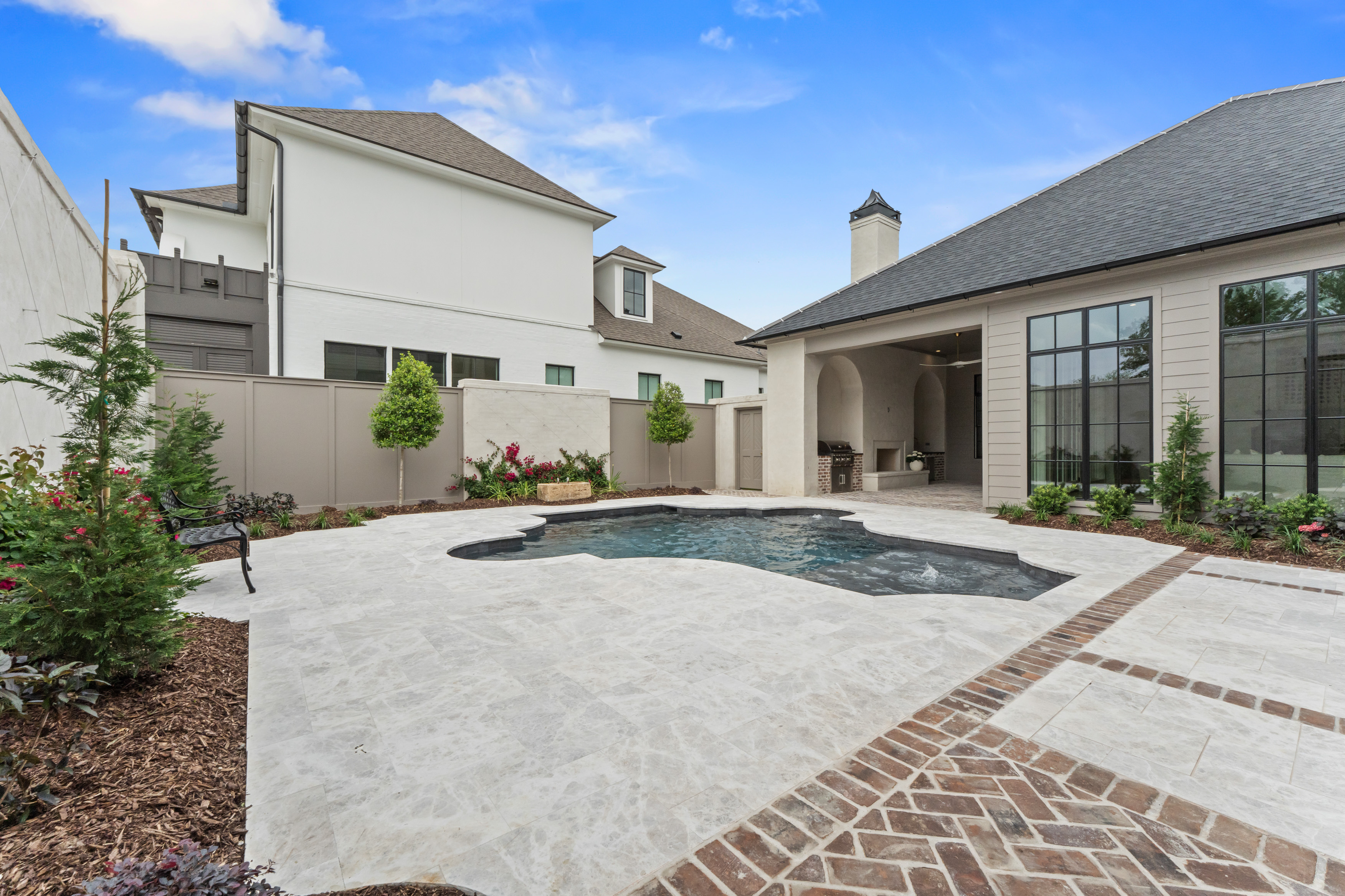 The courtyard pool framed by the home's exterior elevations.