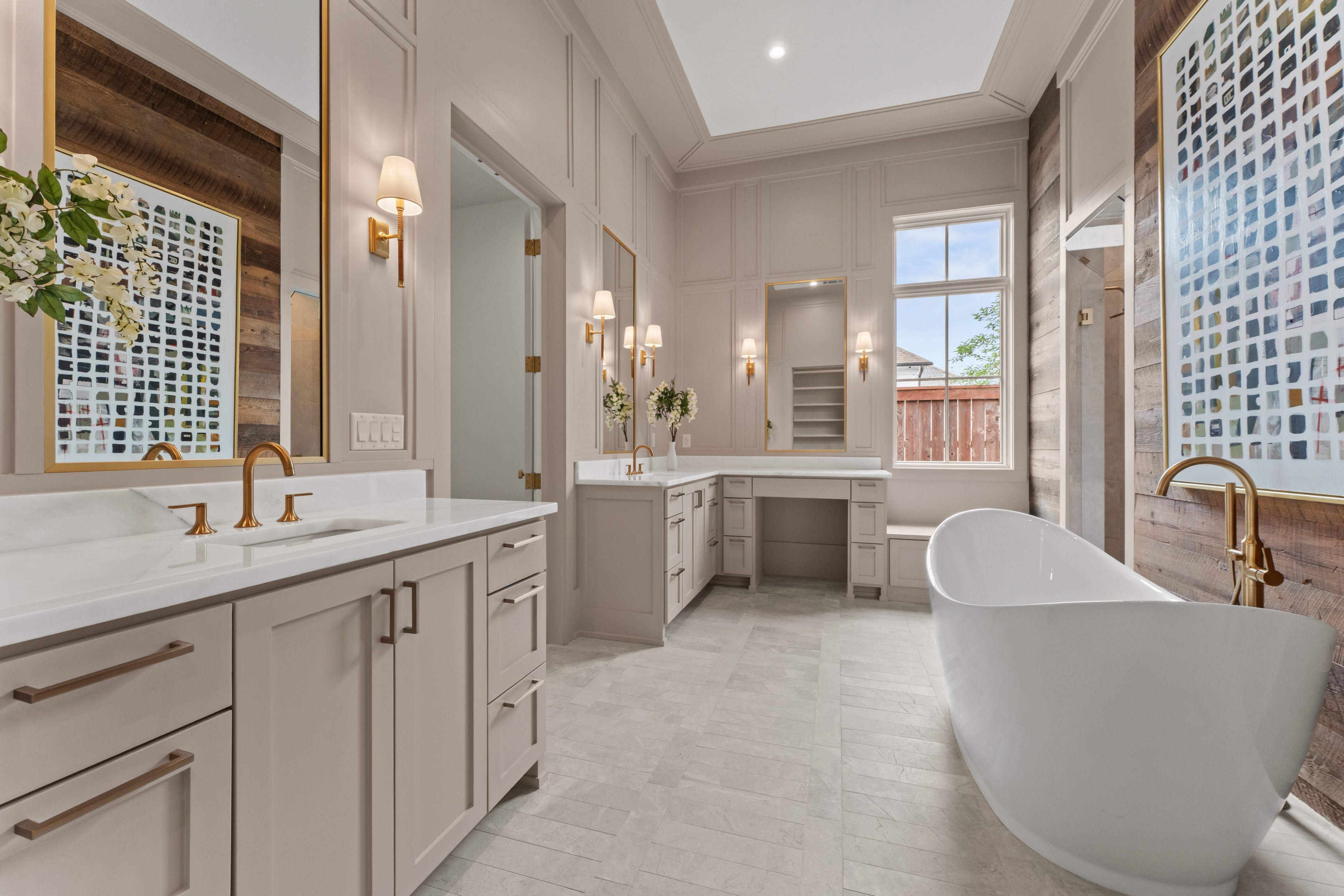 The primary bath pairs a freestanding tub with custom millwork.