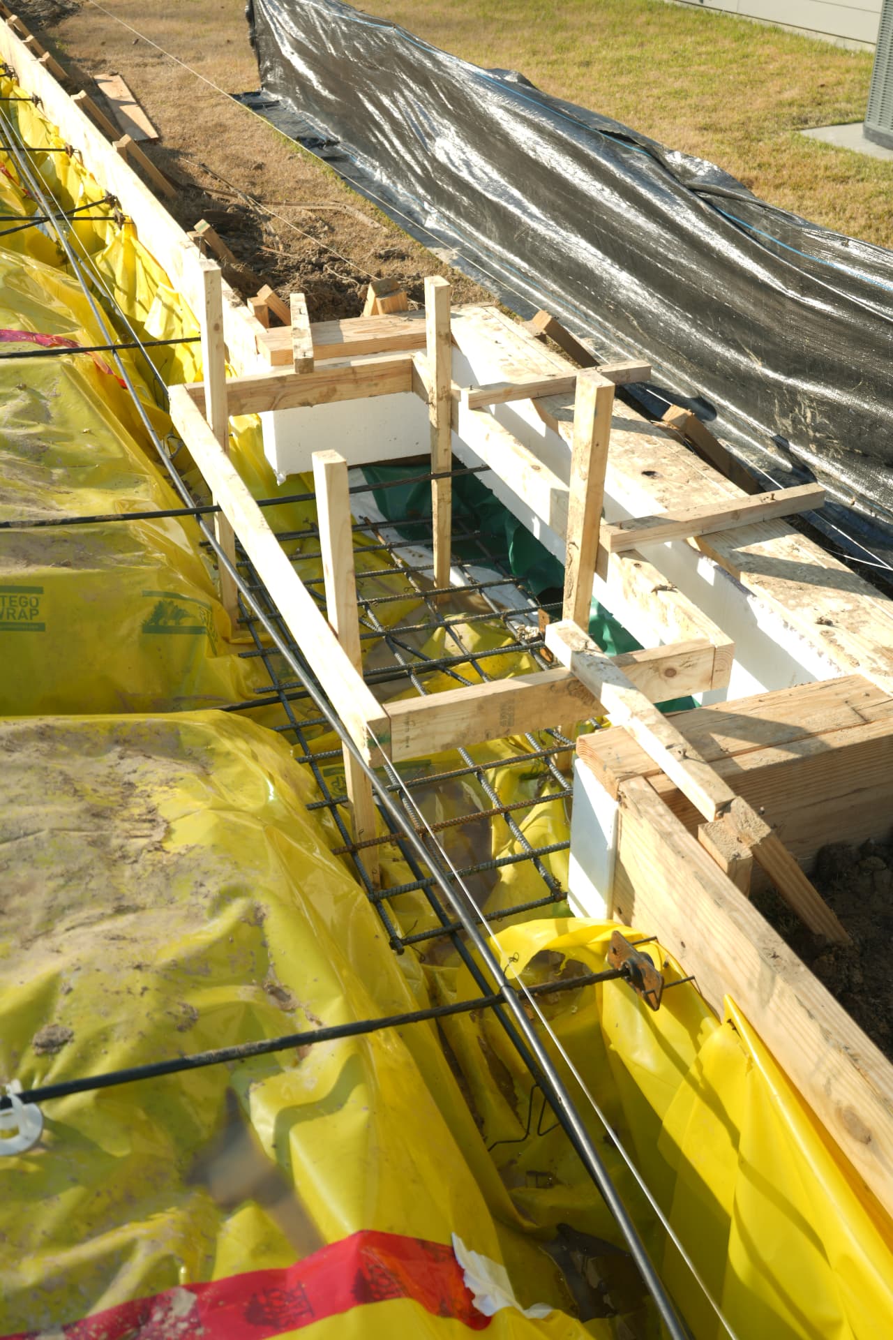 Post-tension cable anchors and formwork detailed at the slab edge.