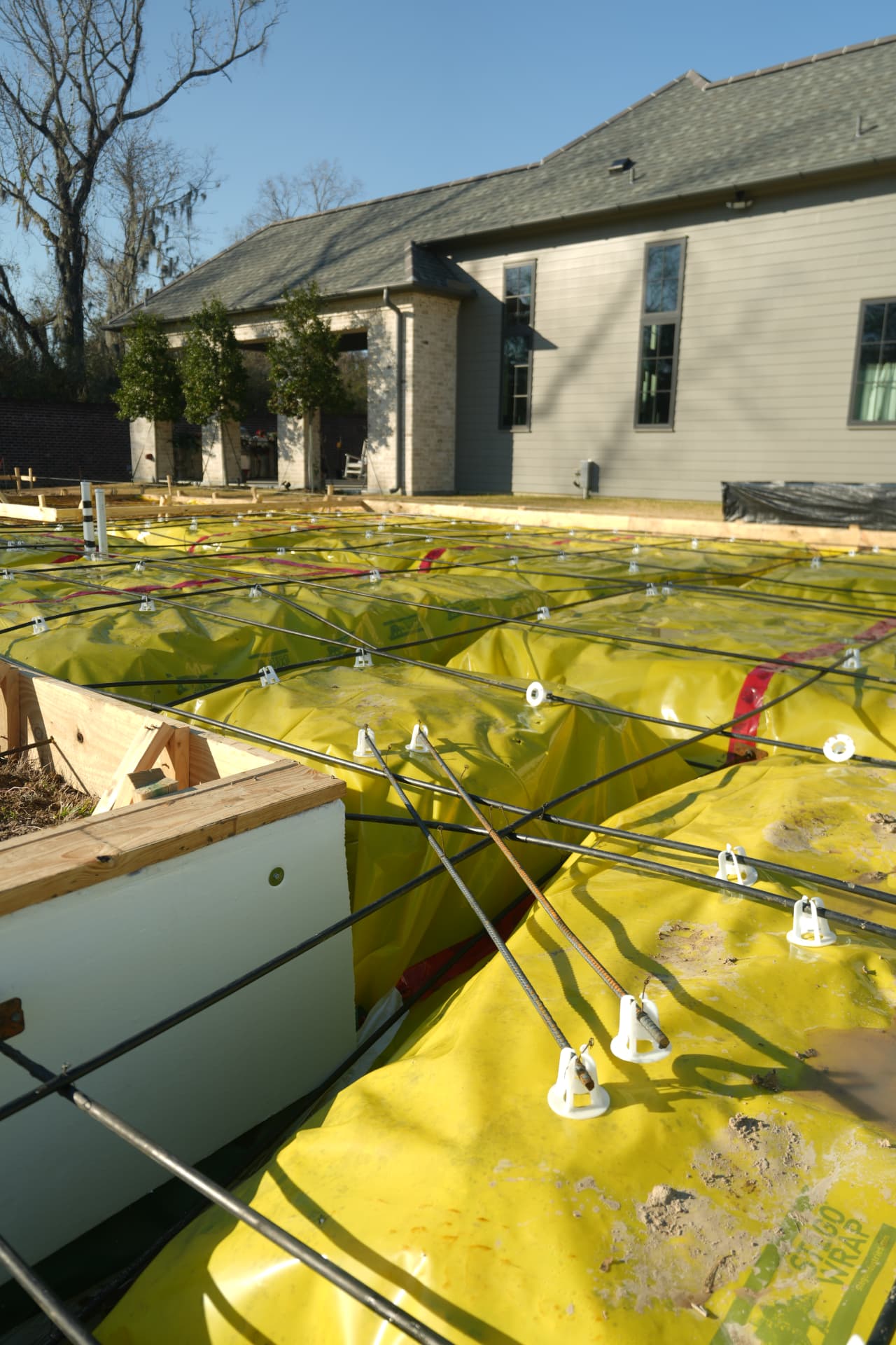 Post-tension cables laid over the vapor barrier ahead of the slab pour at 8646 Hattic Street.