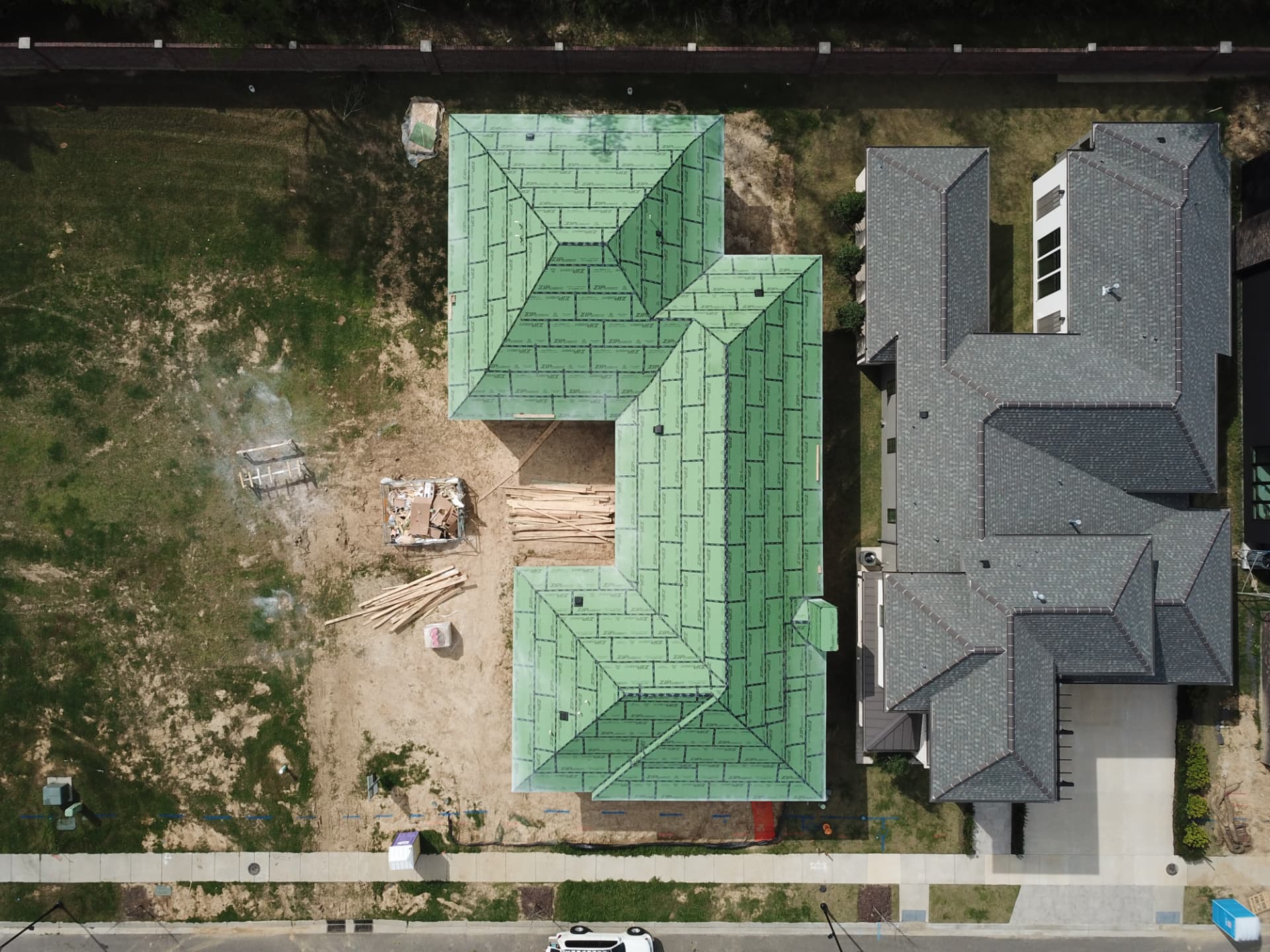Aerial view of the framed roof planes protected with sealed roof underlayment.