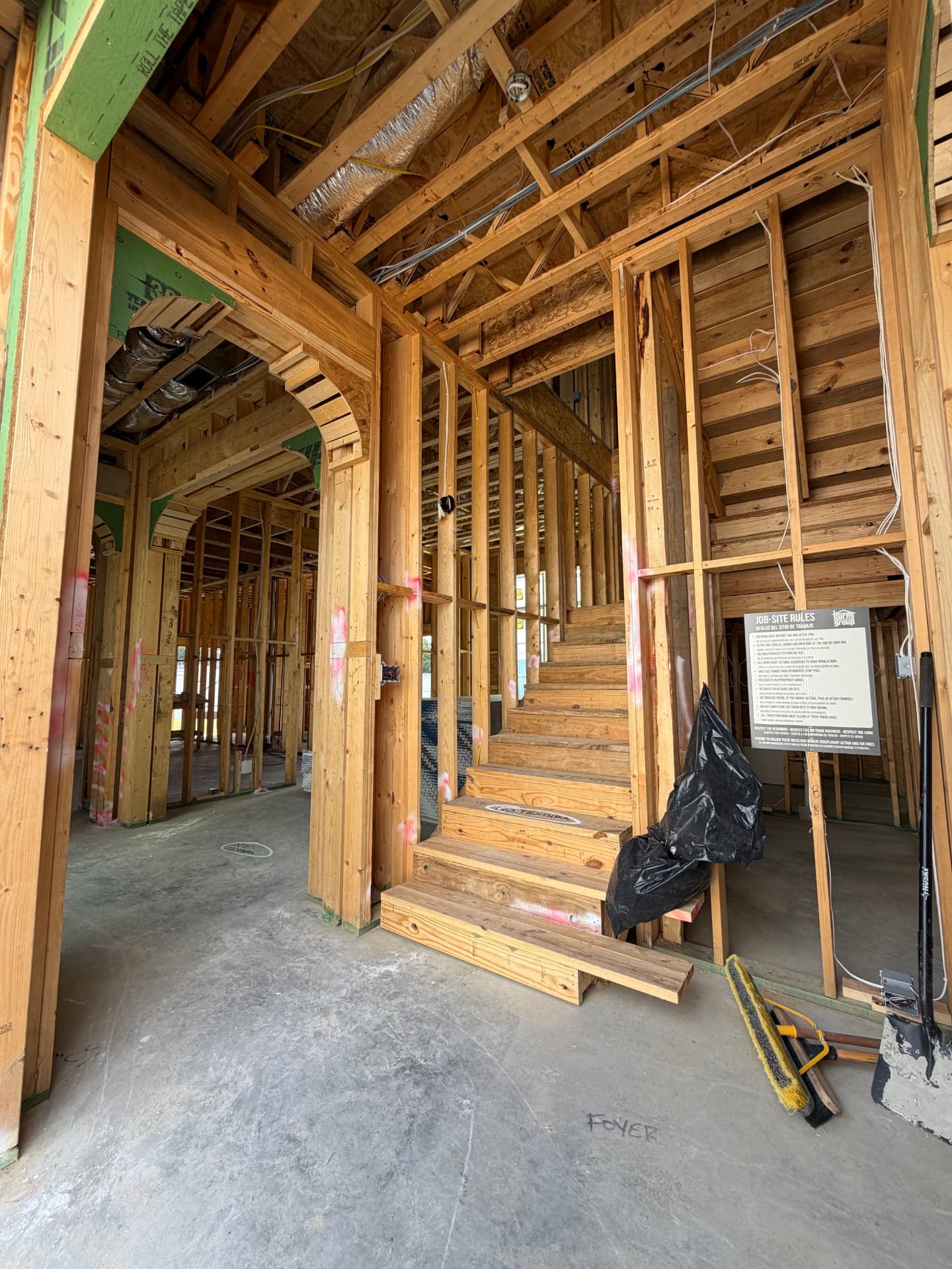 Interior framing and the stair taking shape within the foyer.