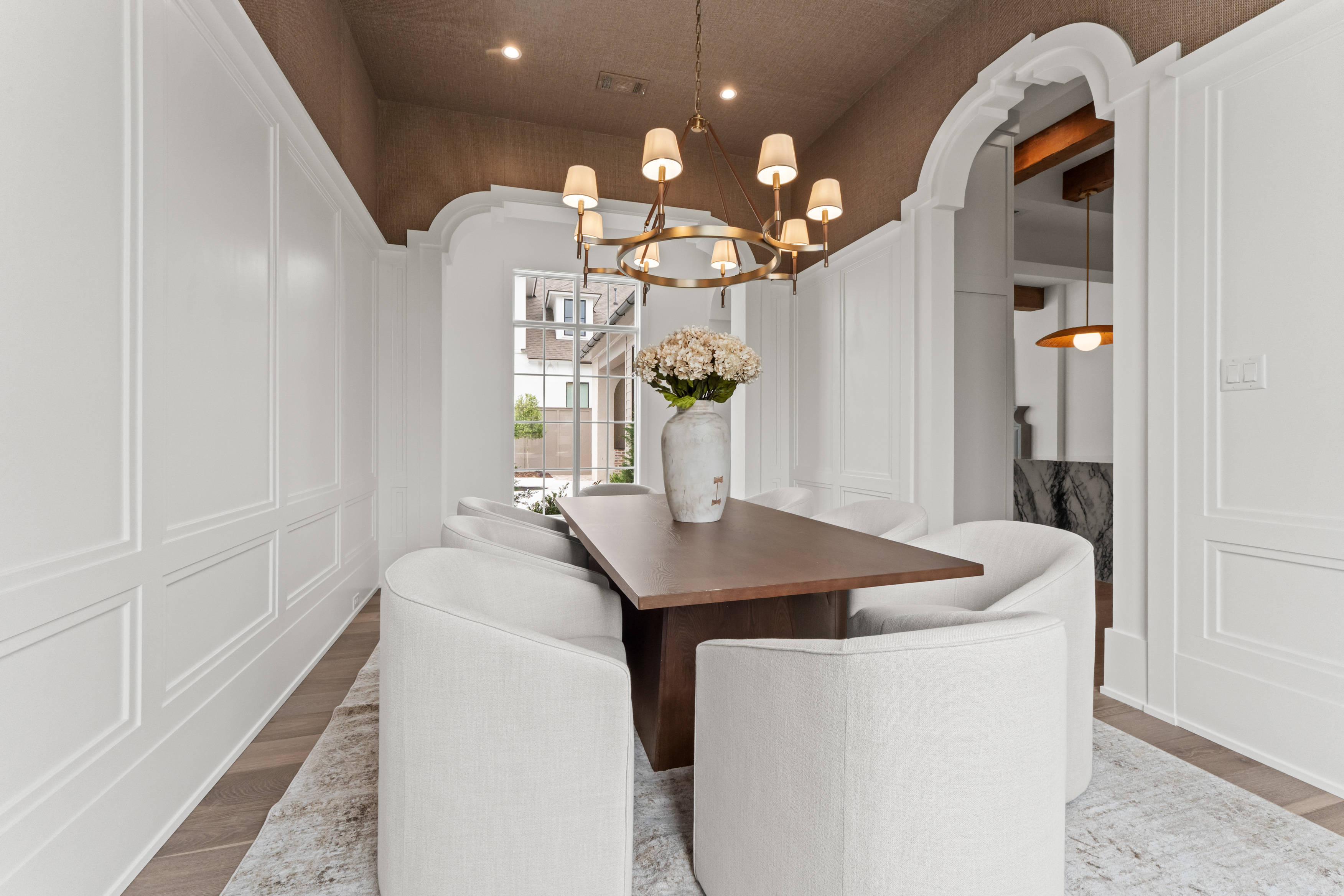 Layered openings, proportioned trim, and durable exterior materials.