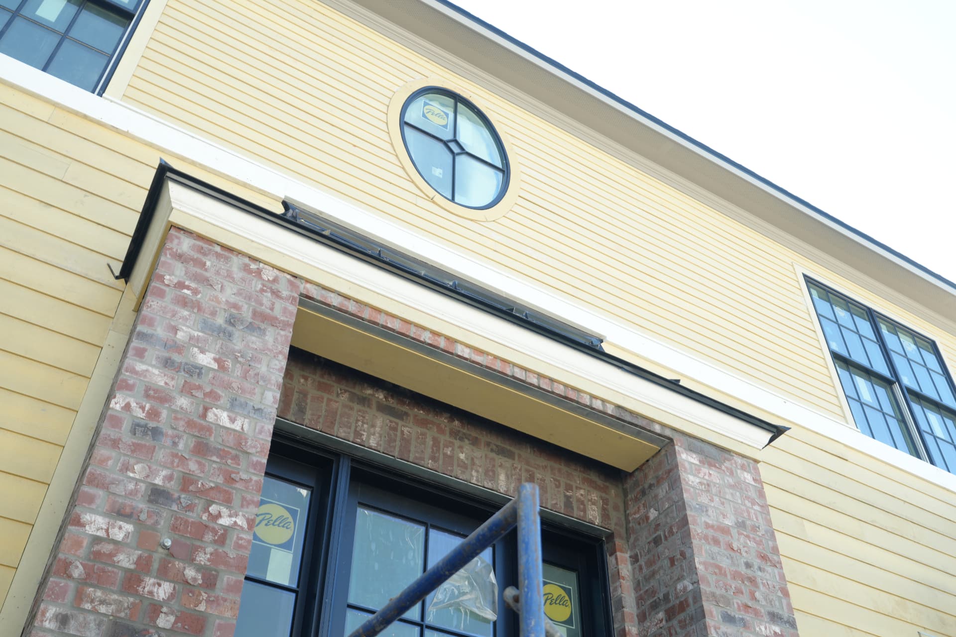 Cladding and window installation at the front elevation.