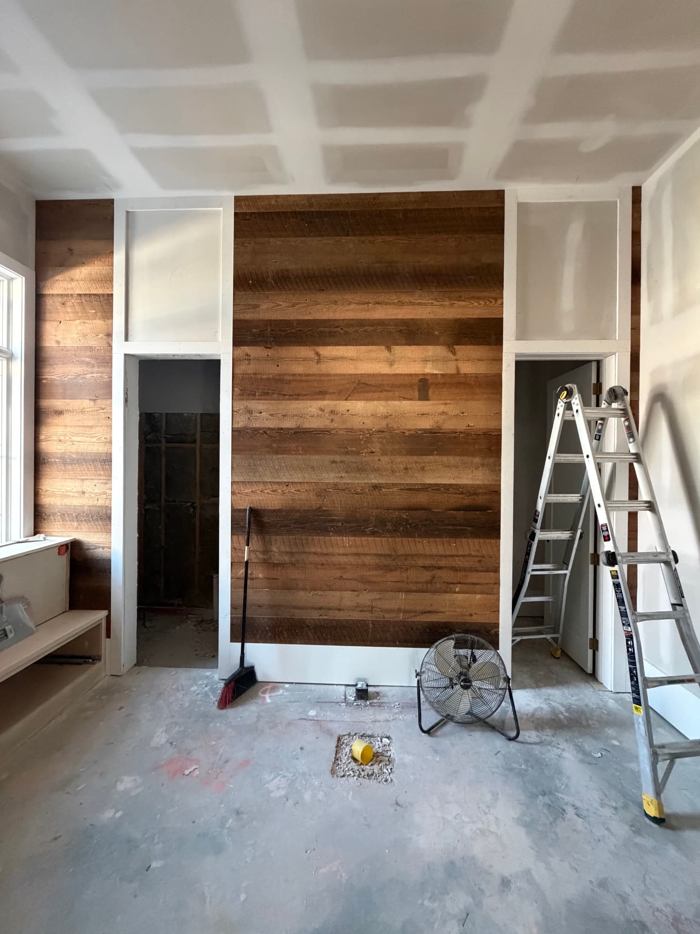 The reclaimed wood feature wall during finish-out.